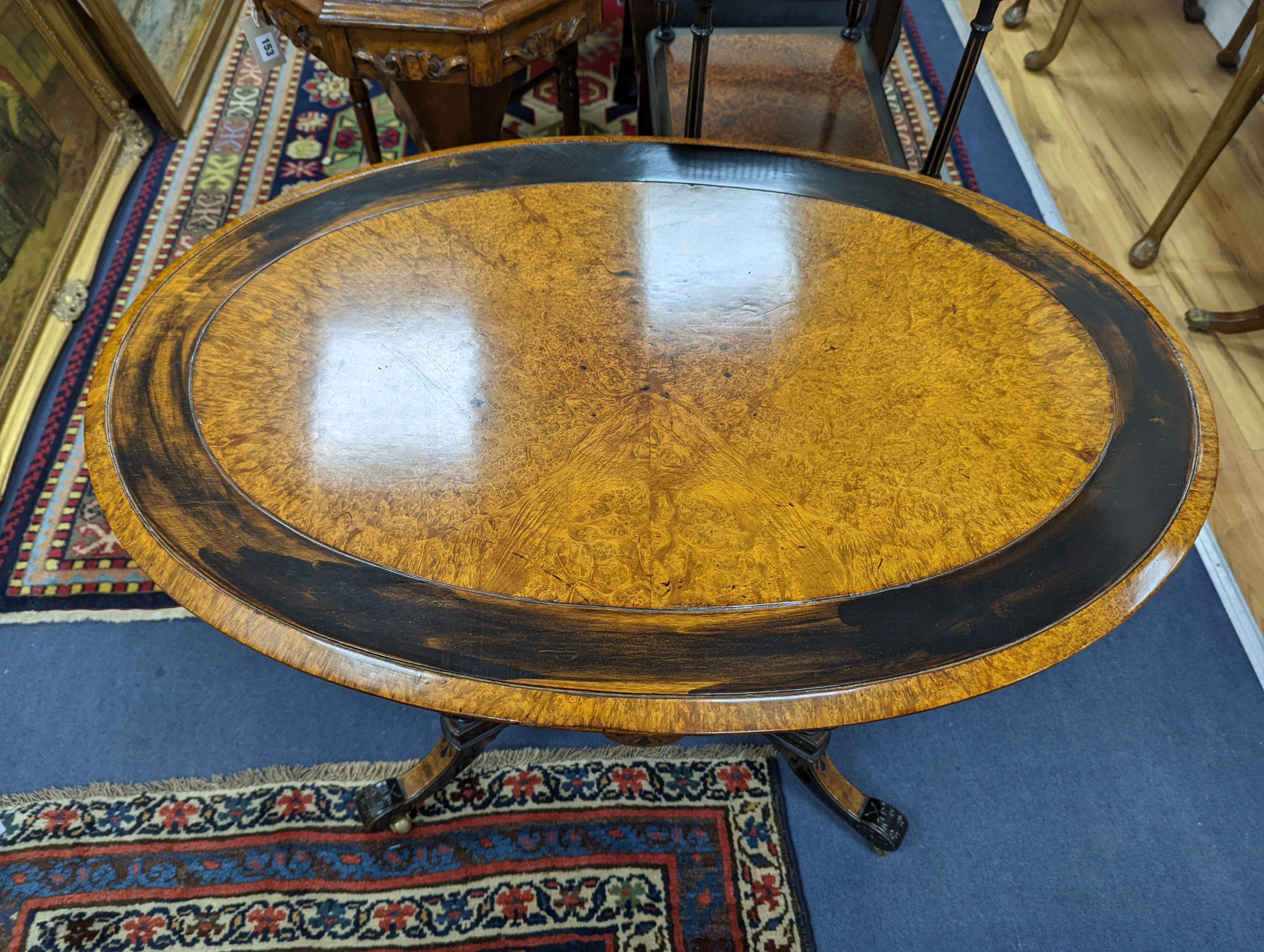 A late Victorian part ebonised oval Amboyna centre table, width 90cm, depth 60cm, height 69cm